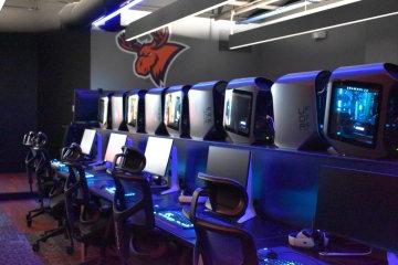 A row of seats and computers in the all-new eSports auditorium.